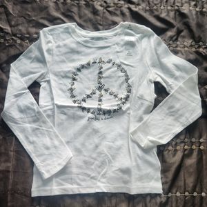 Long sleeve white shirt in size 6-7 with peace sign in front